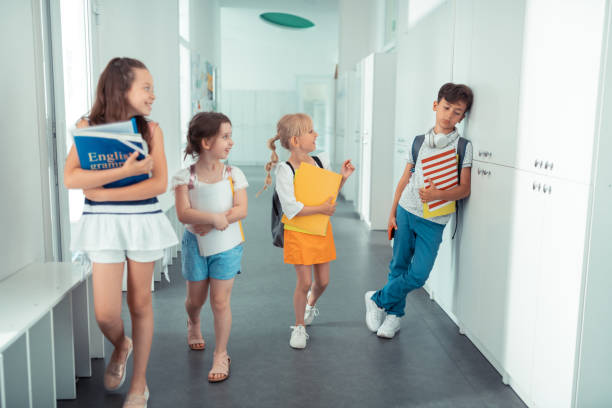 istock Dark-haired boy standing near lockers feeling lonely and sad 1160570028