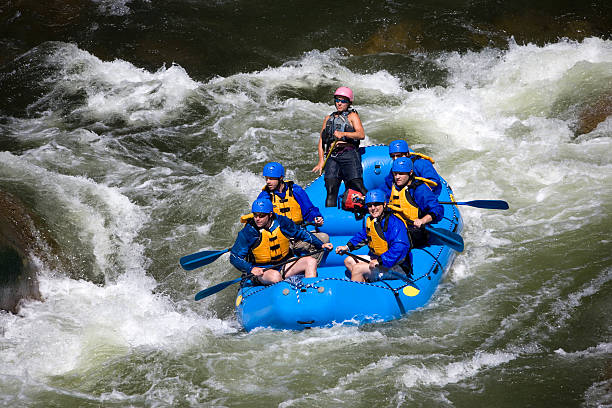 Group of Men and Women White Water Rafting stock photo