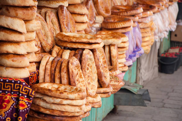 Central asian flat bread, selling at the Osh Bazaar in Bishkek Pile of Non (Nan), a traditional round bread, baked at tandoori or tandir oven bishkek stock pictures, royalty-free photos & images