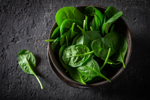 istock Healthy green spinach in small rustic brown bowl 1160572155