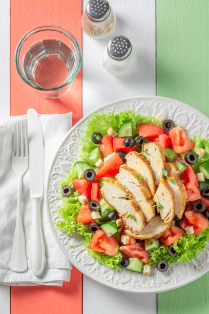 istock Delicious Caesar salad with cucumber, tomatoes and chicken 1160572679