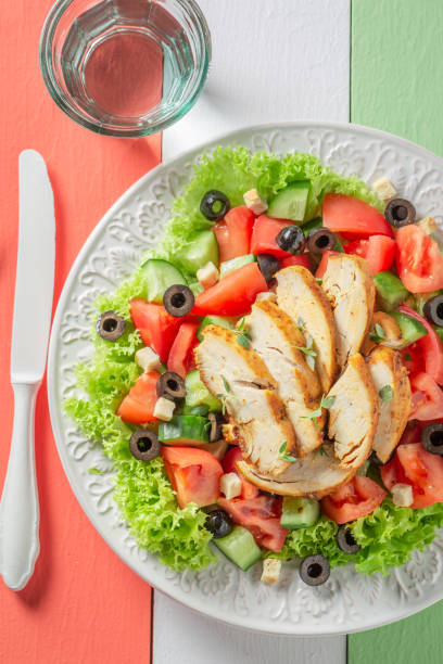 istock Tasty Caesar salad with chicken, tomatoes and lettuce 1160572898