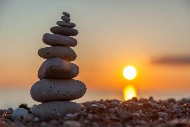 istock The rock cairn on the beach, on a beautiful bright sunset 1160573049