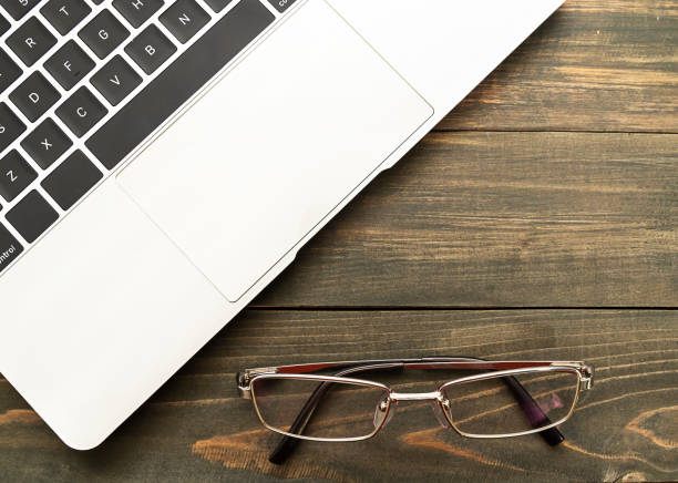 istock Laptop keyboard and eyeglasses 1160574875