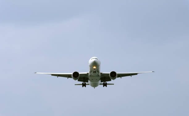 istock air plane in the blue sky front closeup view 1160583374