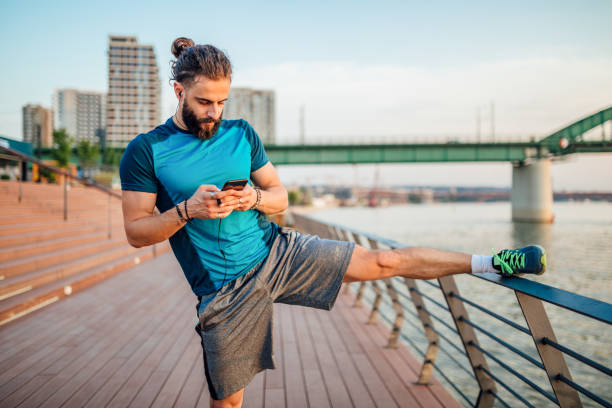 istock Young hipster men resting after training outdoors, using mobile phone 1160583550