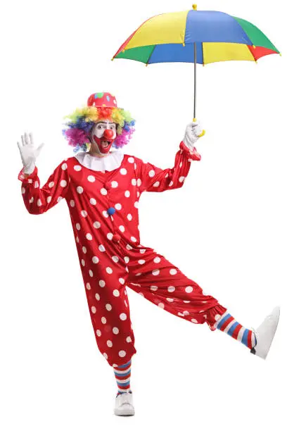 Photo of Cheerful clown holding an umbrella