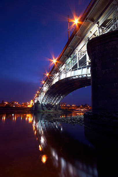 Belgrade, Serbia - February 10, 2019: A panorama of Belgrade seen from the banks of the Sava River by night with reflection. View of the Brankov Bridge and Cathedral Church of St. Michael the Archangel.