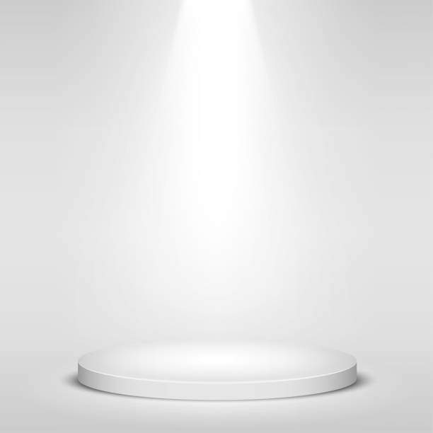 istock White round winner podium on gray background. Stage with studio lights for awards ceremony.  spotlights illuminate. Vector illustration. 1160586846