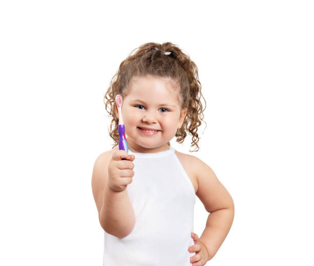 istock Cute blond girl brushing her teeth on isolated white background. 1160586938