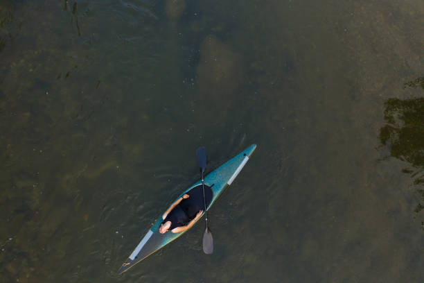 istock Exhausted woman floating on water in kayak 1160589176