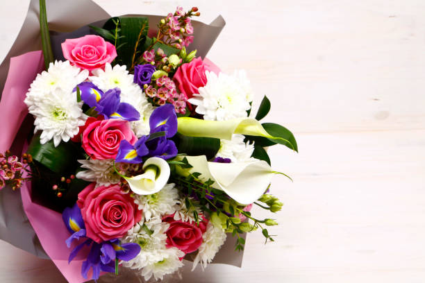 istock bouquet flowers on wooden background 1160594429