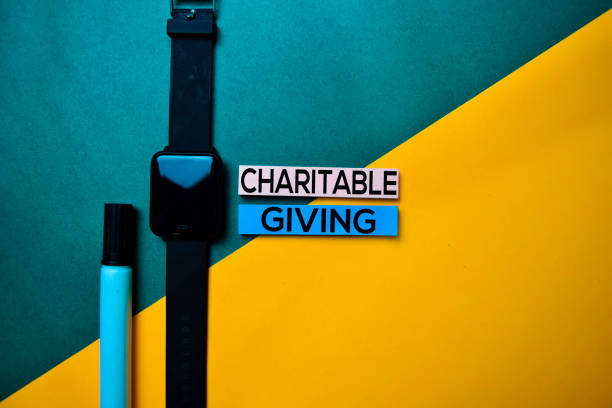 istock Charitable Giving text on top view color table background. 1160597057