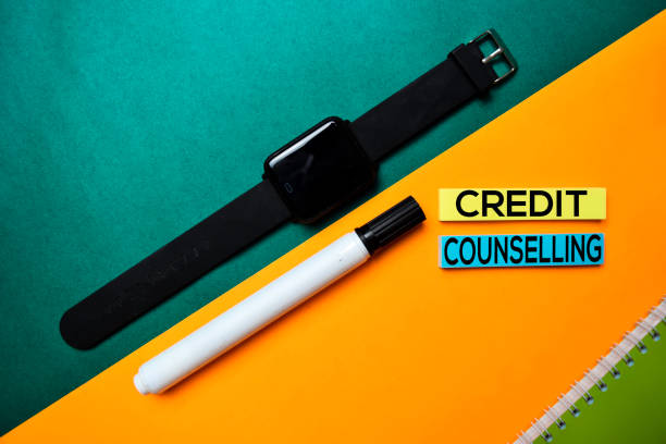 istock Credit Counselling text on top view color table background. 1160597125