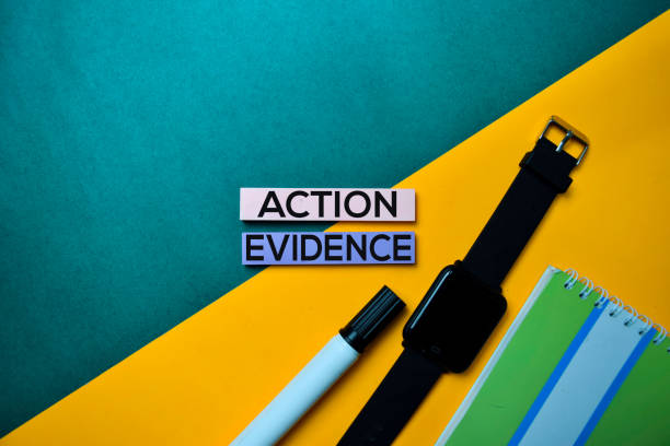 istock Action Evidence text on top view color table background. 1160597305