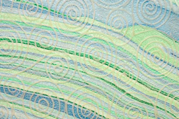 Japanese Washi tissue with white spiral pattern against marbled mulberry paper