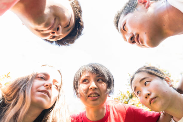 istock Multi-ethnic friends forming huddle outdoors 1160597616