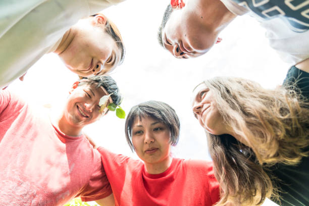 istock Multi-ethnic friends forming huddle outdoors 1160598221