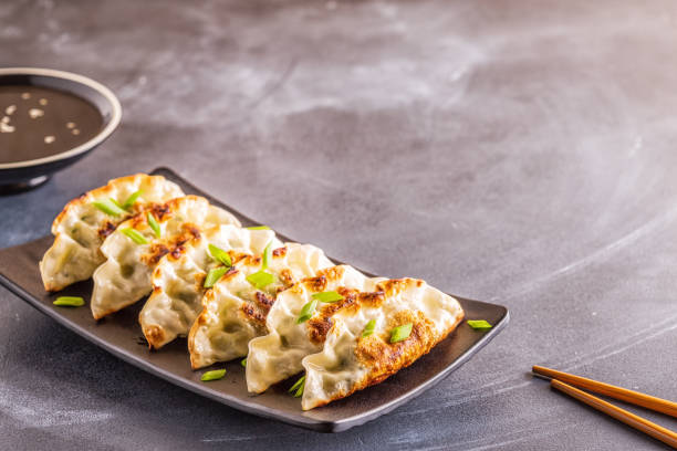 istock Gyoza or dumplings snack with soy sauce, selective focus 1160598388