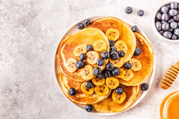 istock Pancakes with banana,  blueberries on white plate 1160598551
