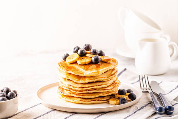 istock Pancakes with banana,  blueberries on white plate 1160598603