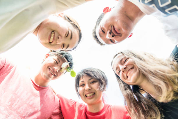 istock Multi-ethnic friends forming huddle outdoors 1160598732