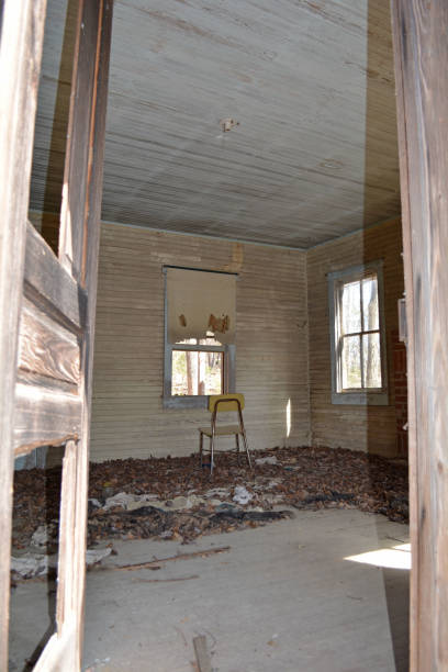 istock Old school chair facing window in abandoned room/house 1160600876