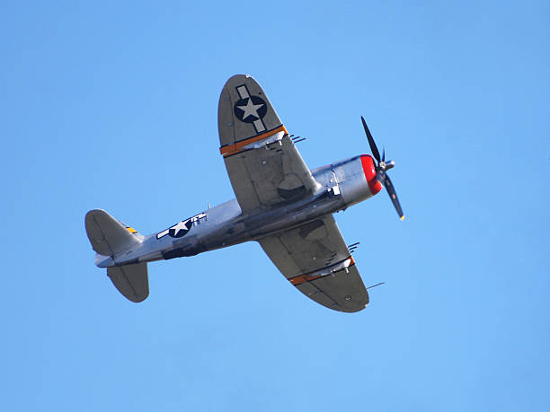 istock WWII fighter P47 Thunderbold airplane flying in clear blue sky 116060302
