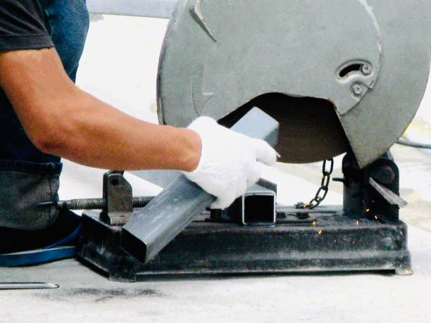 istock Worker Cutting Steel Tube by Cut off Saw 1160603863