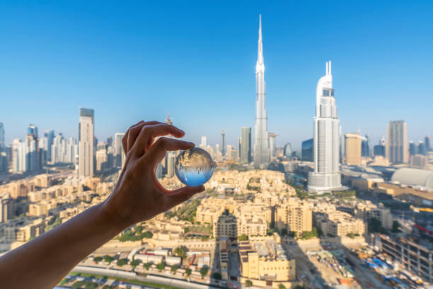 Holding a crystal ball to watch the dubai cityscape,UAE.