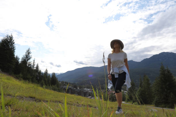 istock Mature woman hikes up mountain meadow 1160605893