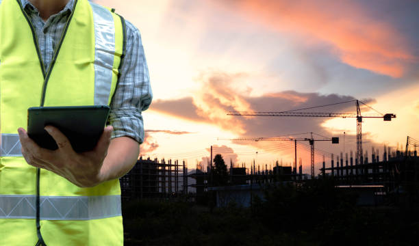 istock Engineering man standing with yellow safety helmet and holding tablet  isolated on white background, work concept 1160608280