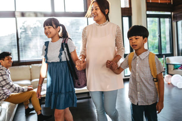 istock Mother taking her children to school 1160610935