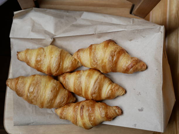 istock five fresh croissants lying on a package from the bakery. delicious pastries 1160611648