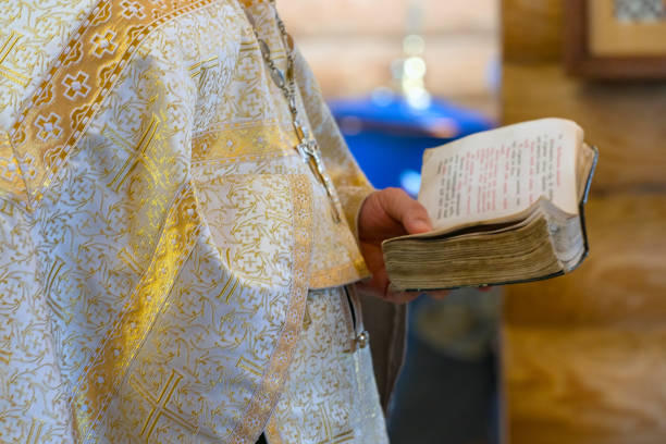istock Book is in the hands of a priest 1160611912