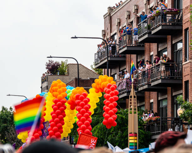 Balcony spectators at Gay Pride Parade Chicago, Illinois. stock photo