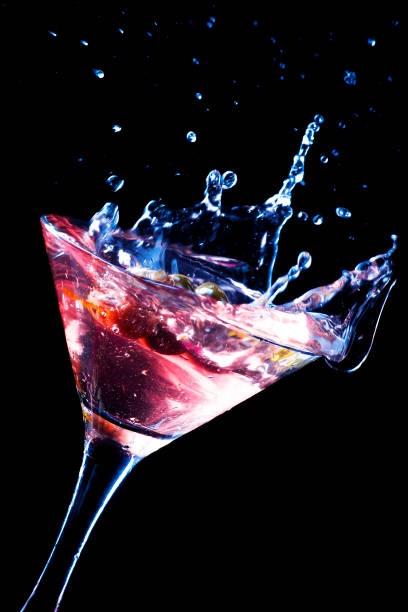 istock A martini glass with green olives on a black background 1160612071