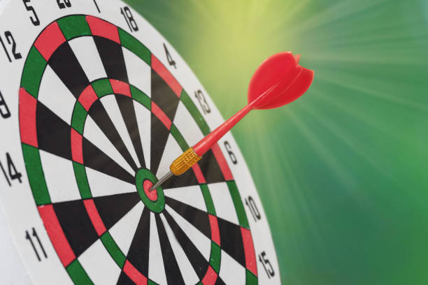 istock Dart arrow hitting in bullseye on dartboard 1160612995
