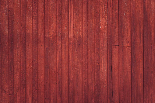 Wooden rural wall outside of red barn in Scandinavia. Background texture
