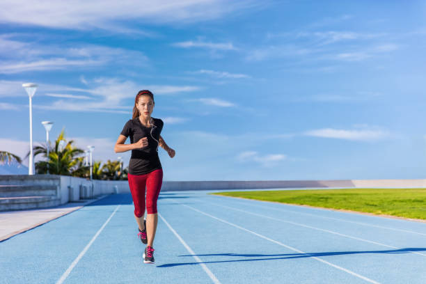istock Athlete runner running on outdoor stadium tracks 1160614855