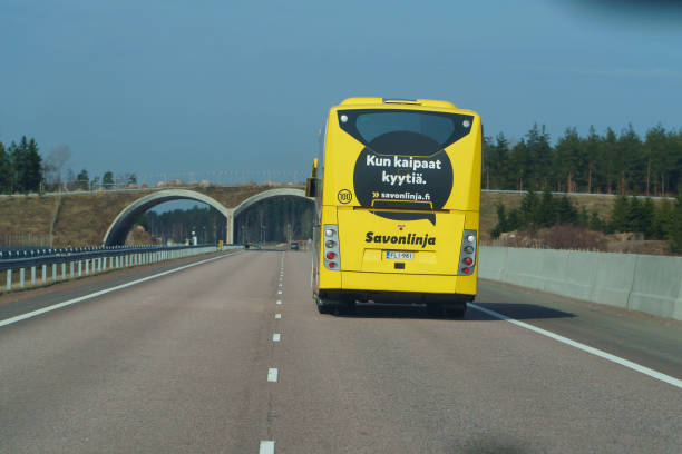 Helsinki nearest, Finland - April 29 2018: Yellow bus on road in Scandinavia. Highway to Helsinki on April 29, 2018