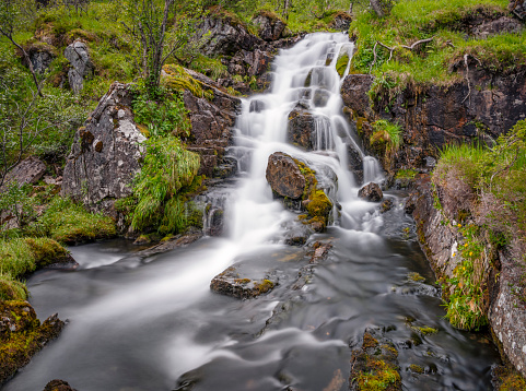Long exposure of a beautiful hidden staircase waterfall. Norway. Nature like in a fairy tale. Nikon D850. Converted from RAW.