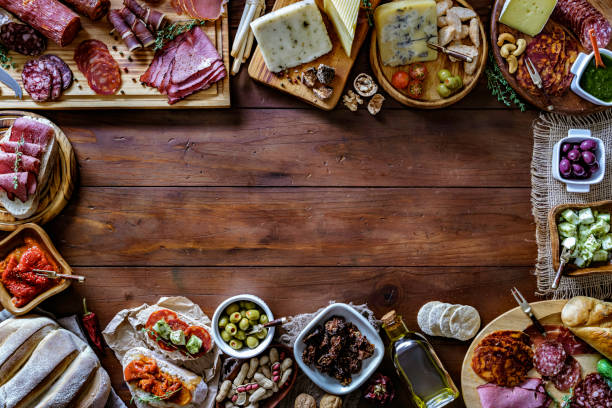 tapas of cured ham and cheese delicious appetizer on rustic wood table with copy space - italian appetizer imagens e fotografias de stock