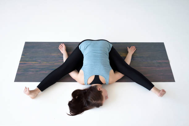 istock Young woman practicing yoga, doing Kurmasana, Tortoise posture, Turtle Pose 1160620707