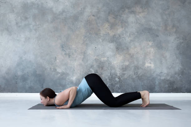 istock woman practicing yoga, doing Ashtanga Namaskara from Sun salutation. 1160620789