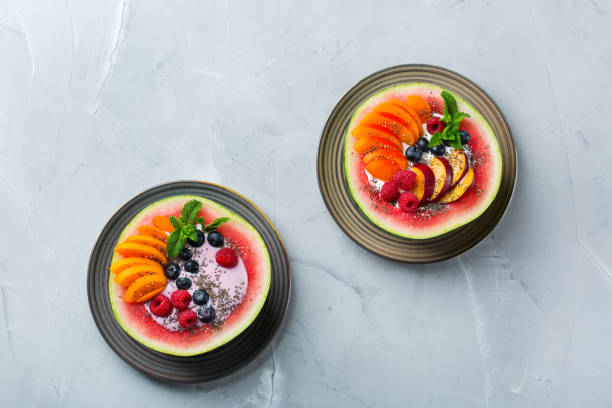 istock Healthy summer breakfast with fruit salad and yogurt in watermelon 1160623721