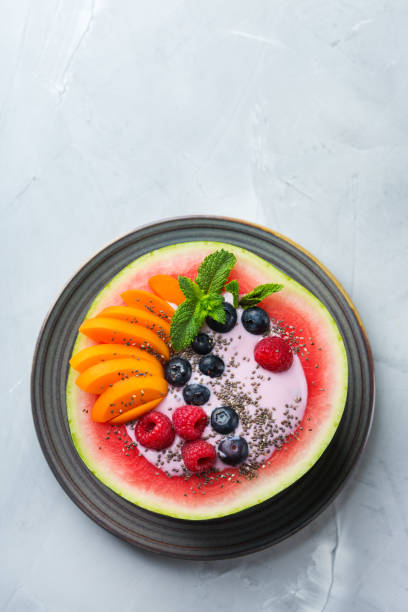 istock Healthy summer breakfast with fruit salad and yogurt in watermelon 1160623729