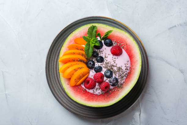 istock Healthy summer breakfast with fruit salad and yogurt in watermelon 1160623742