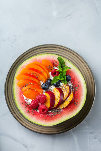 istock Healthy summer breakfast with fruit salad and yogurt in watermelon 1160623743