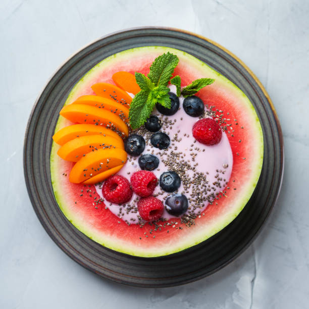 istock Healthy summer breakfast with fruit salad and yogurt in watermelon 1160623767